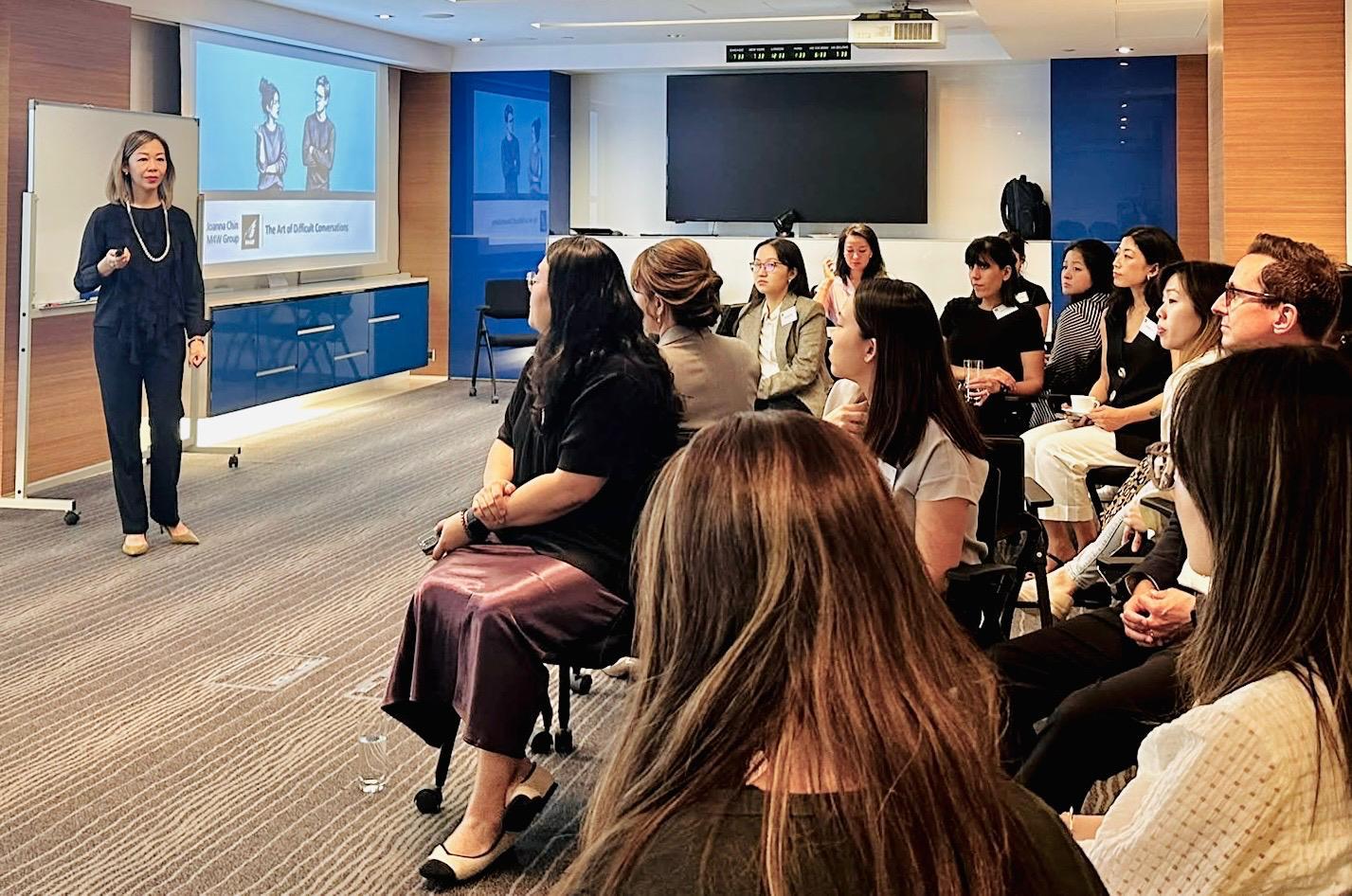 Joanna Chin facilitating a session for an engaged group of professionals
